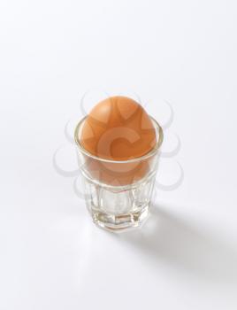 brown egg in glass