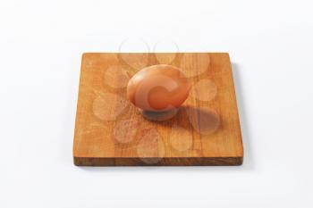 egg on wooden cutting board