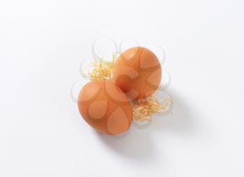 two organic eggs on white background