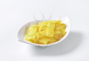 bowl of sliced bamboo shoots on white background