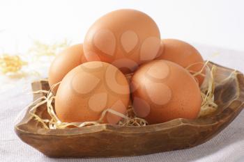 detail of eggs in wooden bowl