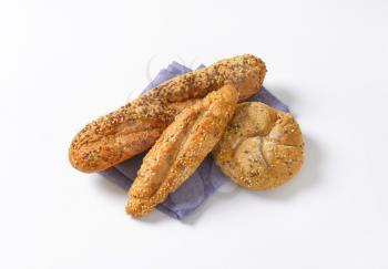 assorted bread rolls on blue napkin