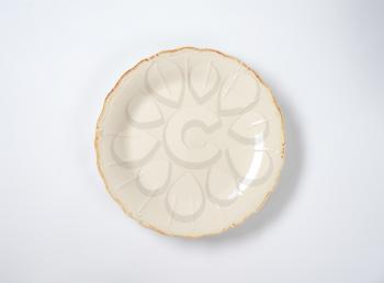 dinner plate with embossed lines and subtle scalloped edge