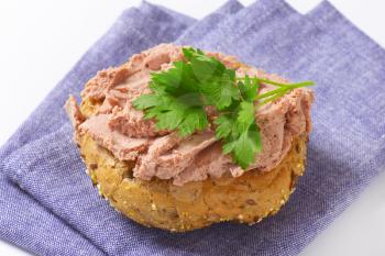 Bulkie roll with pate on blue fabric napkin