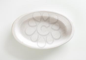 Empty deep oval porcelain baking dish