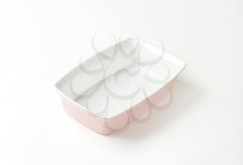 Deep rectangular ceramic baker - pink on the outside, white on the inside