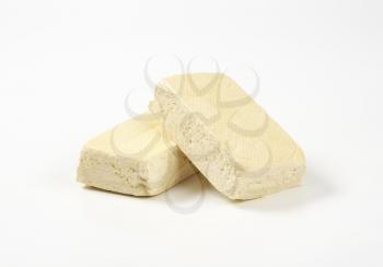 Two blocks of firm tofu (soybean curd)