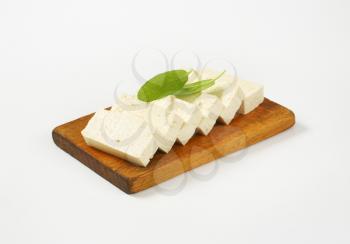 Slices of fresh tofu on cutting board