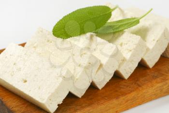 Slices of fresh tofu on cutting board