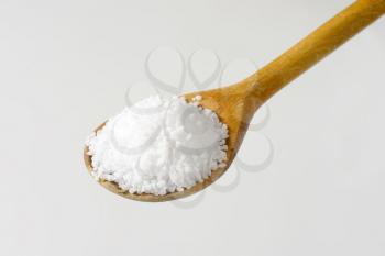 Coarse grained salt on wooden spoon