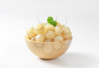bowl of pickled onions on white background