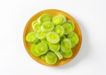plate of leek slices on white background