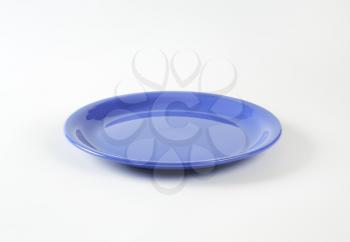 Rimless round blue ceramic plate
