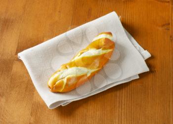 Soft white bread roll on linen place mat
