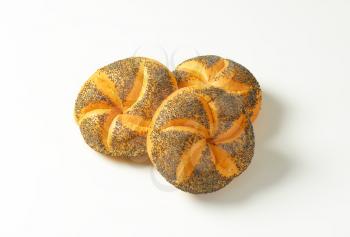 three fresh poppy seed buns on white background