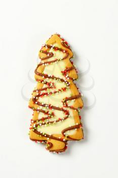 Christmas tree shaped cookie decorated with icing and sprinkles