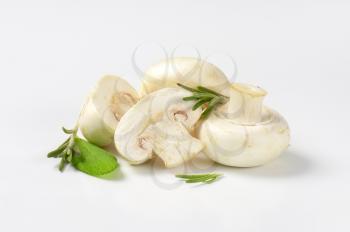 Raw white mushrooms with herbs