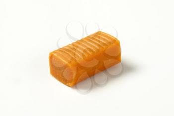 Chewy toffee candy on white background