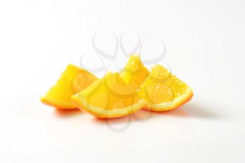 Pieces of fresh orange on white background