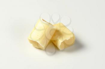 Two milk chewy candies on white background