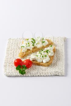 bread with cottage cheese and chives on white mat