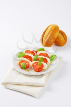 plate of caprese salad and fresh buns
