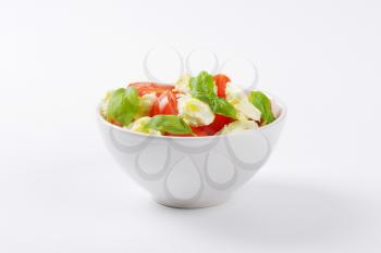 bowl of fresh caprese salad on white background