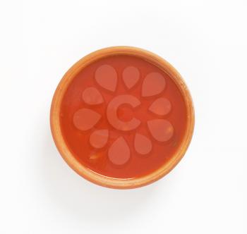 tomato soup in terracotta bowl