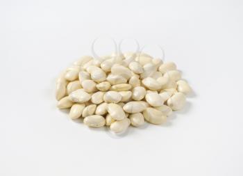 heap of raw white beans on white background