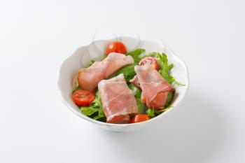 bowl of salad greens with Black Forest ham and cherry tomatoes