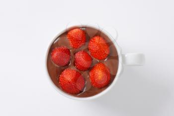 cup of chocolate pudding with fresh strawberries