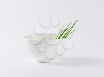 fresh chives in white bowl