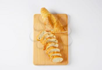 sliced loaf of French bread on cutting board