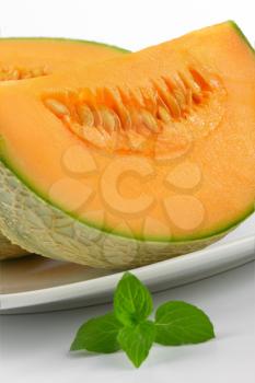 sliced cantaloupe melon on white plate
