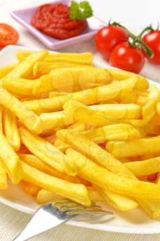 portion of French fries with tomato sauce