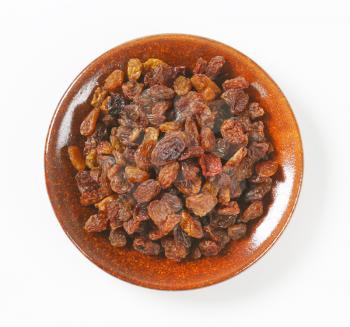 heap of raisins on plate