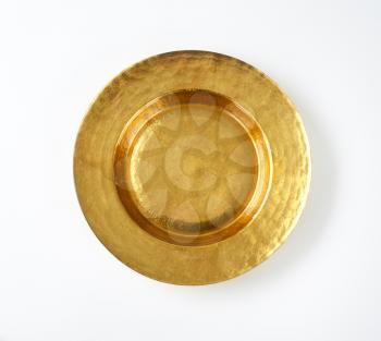 Empty gold plate with wide rim
