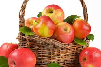 fresh red apples in a wicker basket