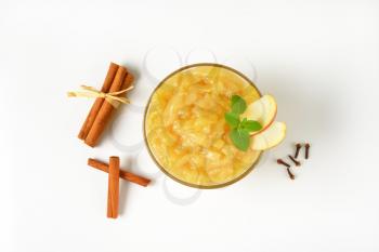 bowl of apple sauce and spice on white background