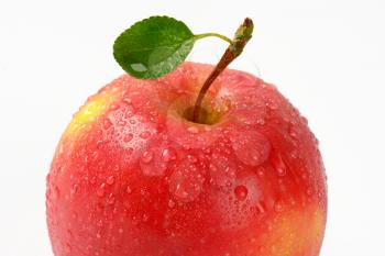 detail of washed red apple on white background