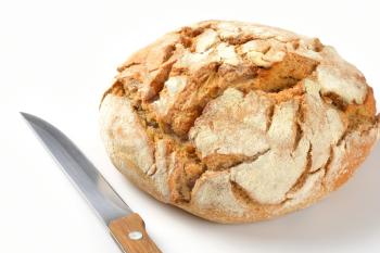 close up of freshly baked bread and kitchen knife