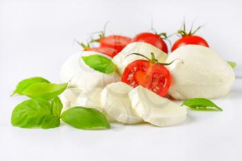 close up of mozzarella, cherry tomatoes and fresh basil - ingredients for caprese salad