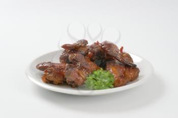 sweet and spicy BBQ chicken wings on plate