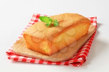 loaf of pound cake on wooden cutting board