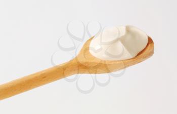 Creme fraiche on a wooden spoon