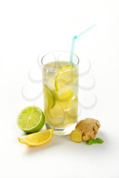 glass of homemade ginger ale with lemon, lime and ice