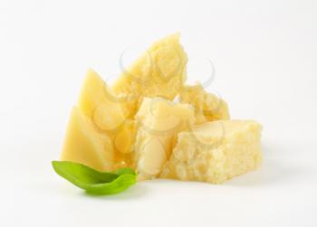 Pieces of Parmesan cheese on a white background