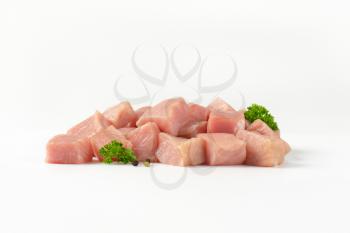 Diced lean raw pork on white background