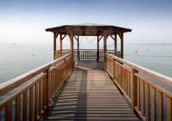 Wooden pier and gazebo on Lake Garda, Italy