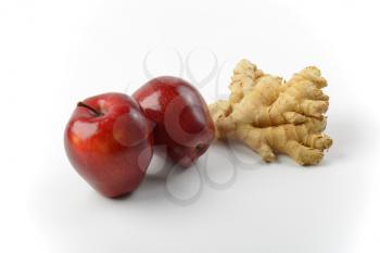 two fresh red apples and ginger root